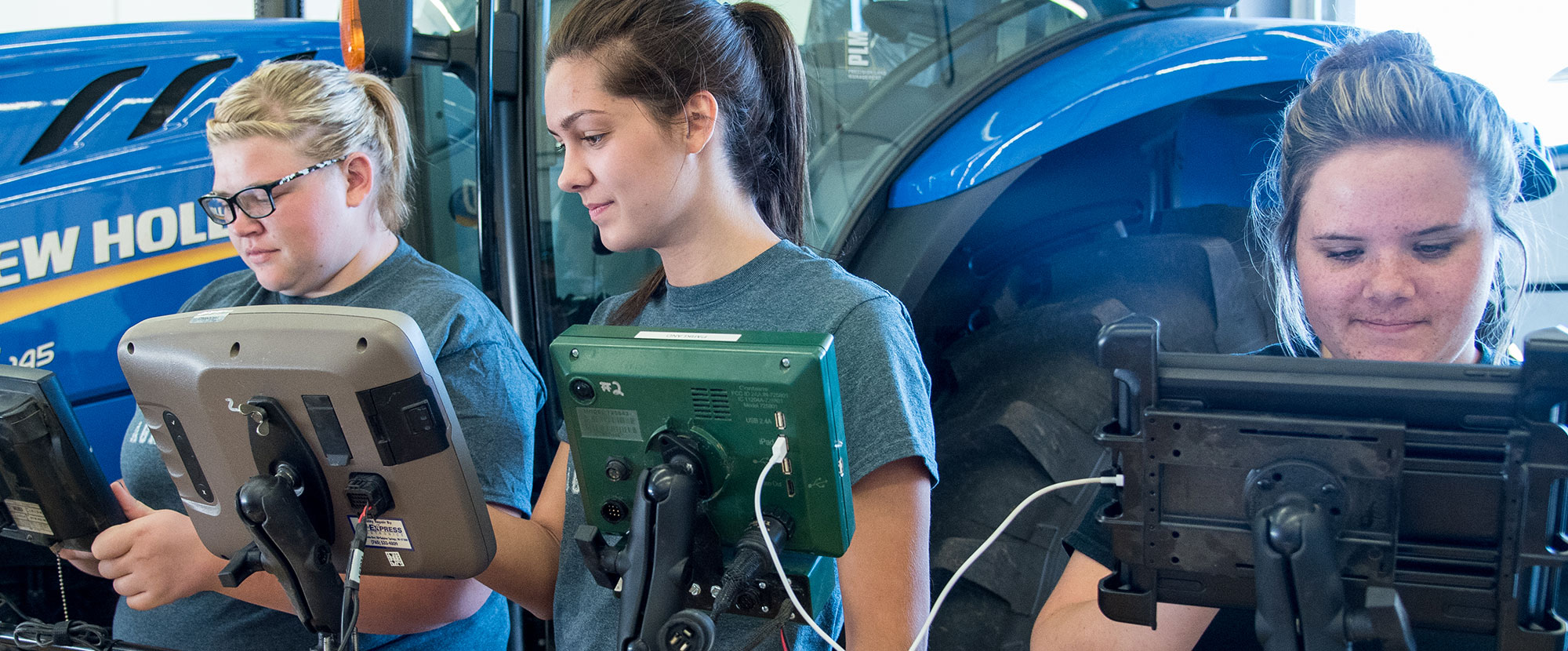 Three female students with high tech equipment